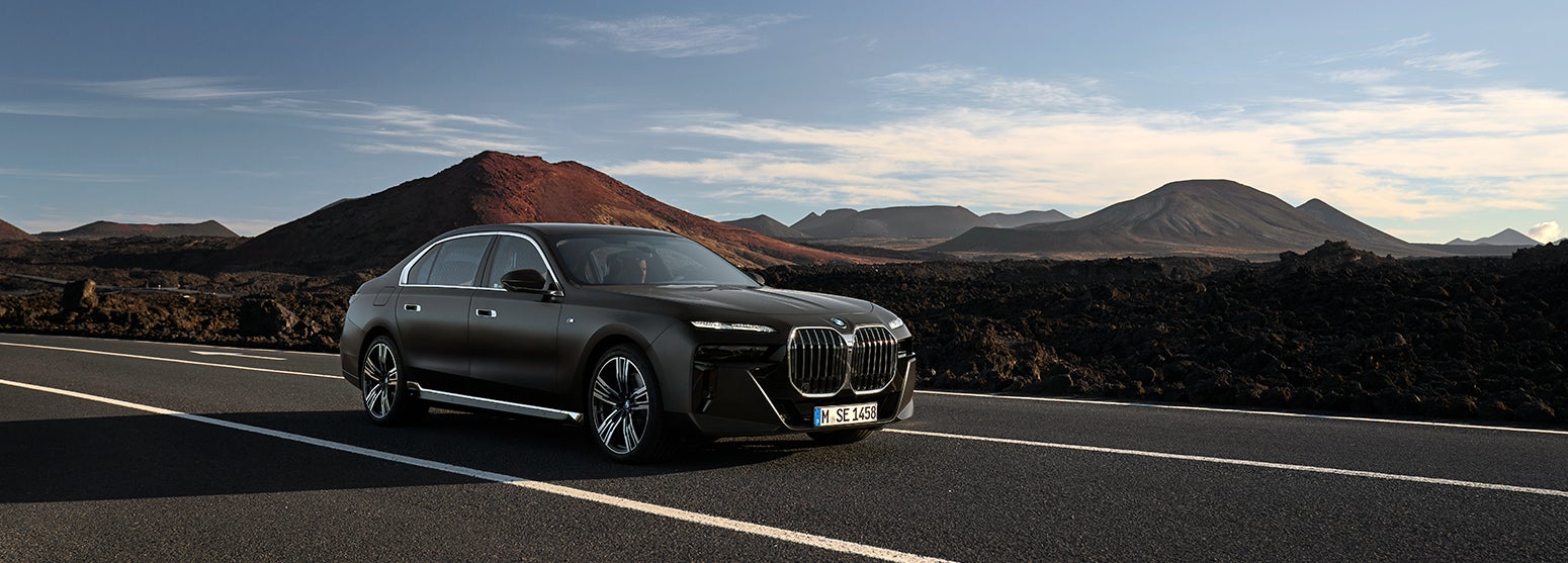 Black BMW i7 driving down road with mountainous background | Flemington BMW in Flemington NJ