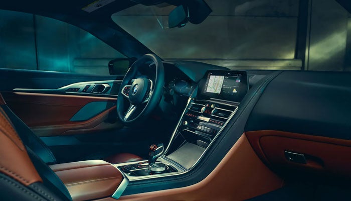Interior view of the BMW 8 Series Coupe showcasing driver-oriented controls.